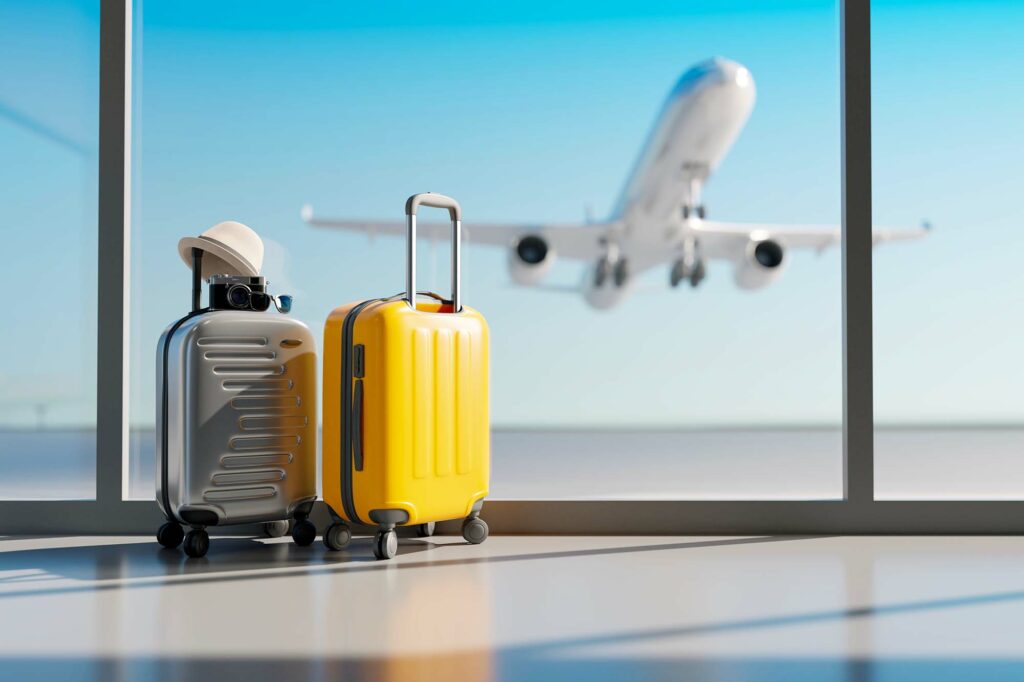voyage avion : deux valises et un avion qui décolle en arrière plan