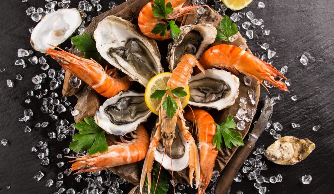 Fresh seafood on black stone, close-up.