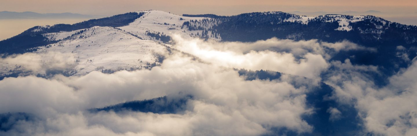 Spectacular clouds formation in the Schneidenbach valley. Taken from the Hohneck on a beautiful cold winter day with a lot of snow.