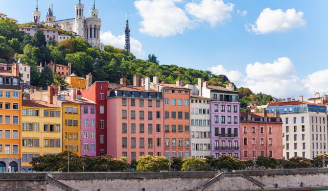 Scenic view of St. Georges district of old Lyon with its color houses and Basilica of Notre-Dame de Fourviere on the background