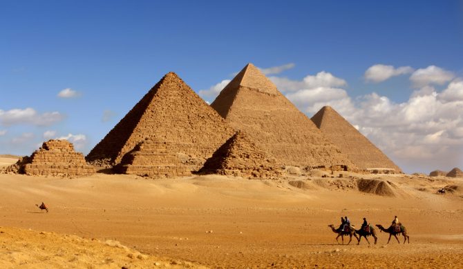 pyramids giza cairo in egypt with camel caravane panoramic sceni