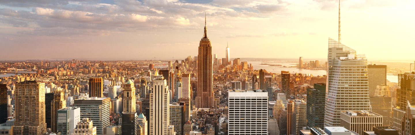 New York City skyline with urban skyscrapers at sunset, USA.