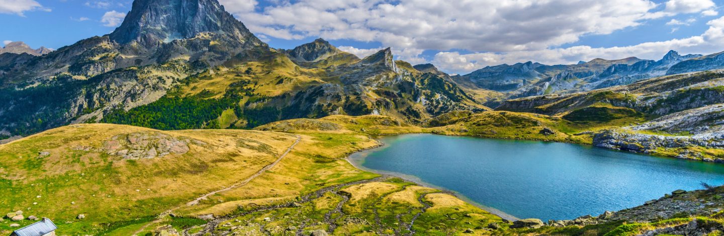 View at Midi Ossau mountain peak and Lake Roumassot, in Ayous-Bious valley in French Atlantic Pyrenees, as seen in October. Aquitaine, France.