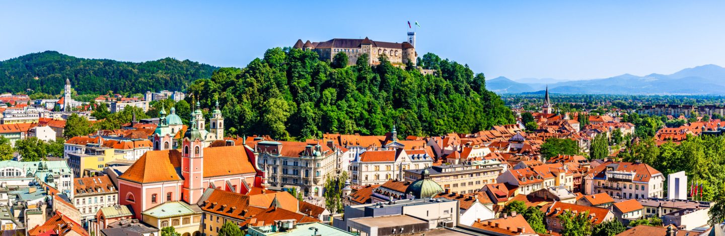 Ljubljana, Slovenia: Panorama of old town and the medieval Ljubljana castle on top of a forest hill.