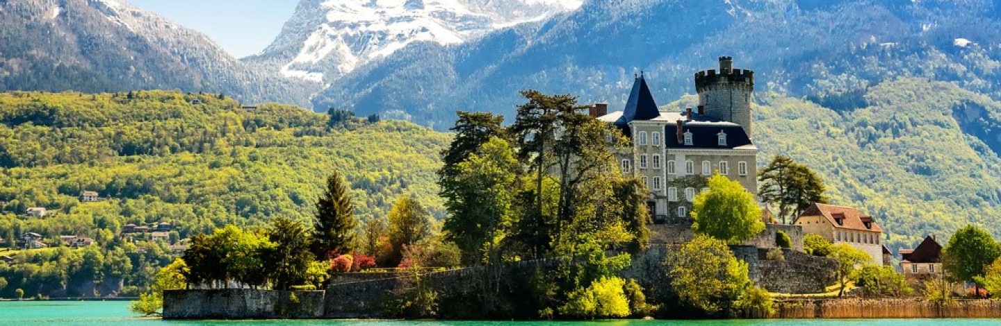 Lake Annecy, a view of the Duingt Castle (Château de Duingt) and the surrounding French Alps. France