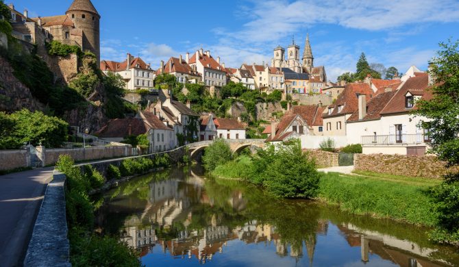 Historical Old town of medieval city of Semur en Auxois reflecting in Armancon river, Cote d'Or, Burgundy, France