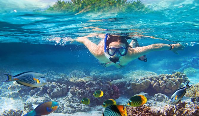 Young women at snorkeling in the tropical water