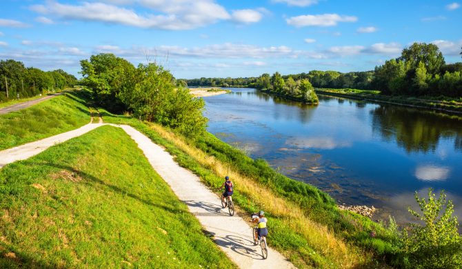 Chatilllon sur Loire, France - August 9, 2023: Cyclists ride on thefra cycle path along the Loire River in France.