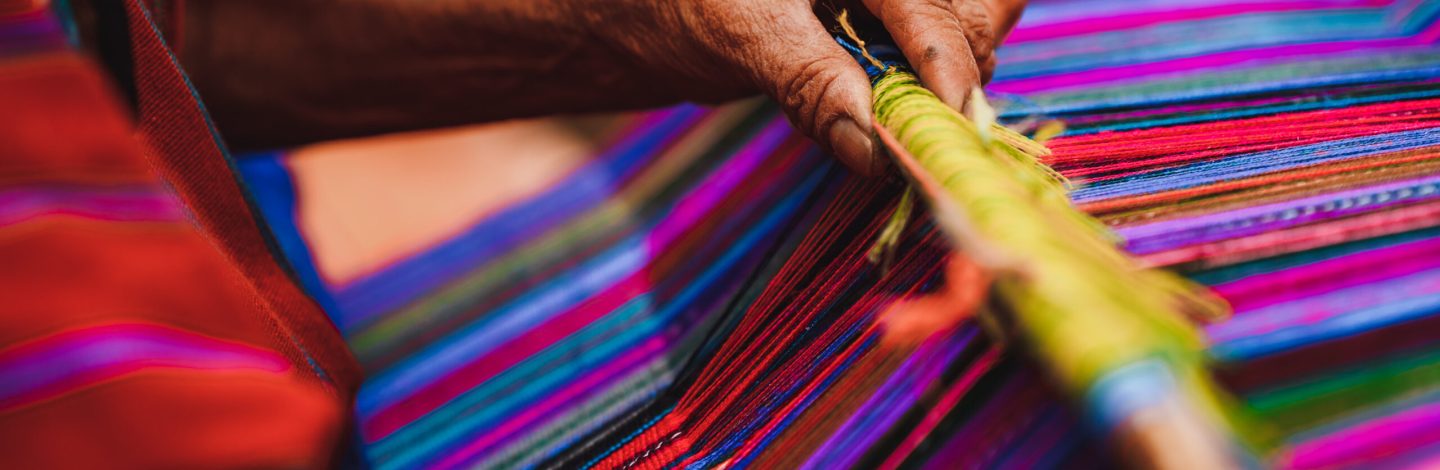 Close up shot of Guatemalan handcraft textile and colorful patterns made by indigenous woman