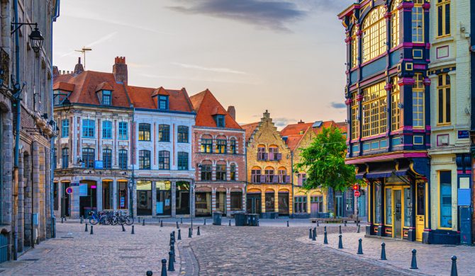 Vieux Lille old town quarter with empty narrow cobblestone street, paving stone square with old colorful buildings in historical city centre, French Flanders, Hauts-de-France Region, Northern France