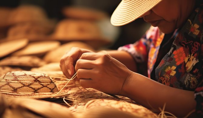 A woman weaves traditional straw hats. The concept of handicraft and tradition.