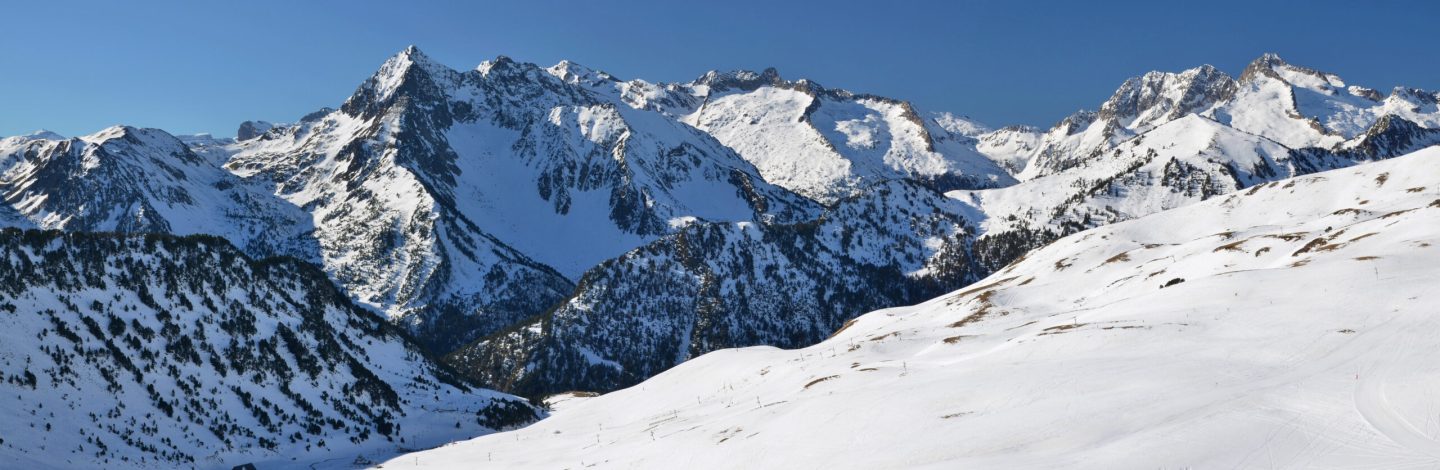 Haute Pyrenees panorama from Saint Lary Soulan via Neouvielle massif in winter, following the annex of Aure valley.  Slopes of the ski resort are at foreground