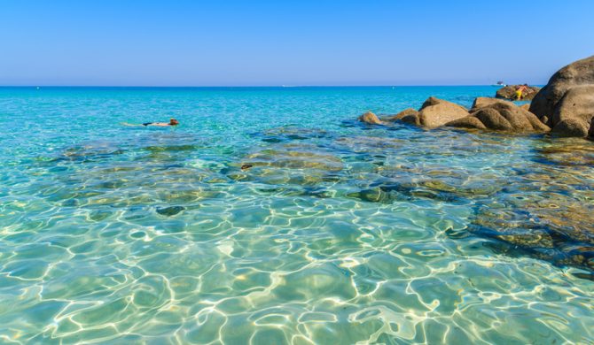 Crystal clear sea water with rocks on Saleccia beach, Corsica island, France