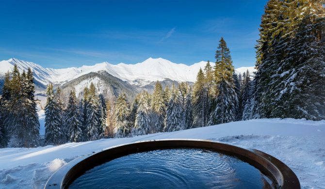 ski resort in the mountains. a hot tub with spa near a winter forest with a snow covered mountains