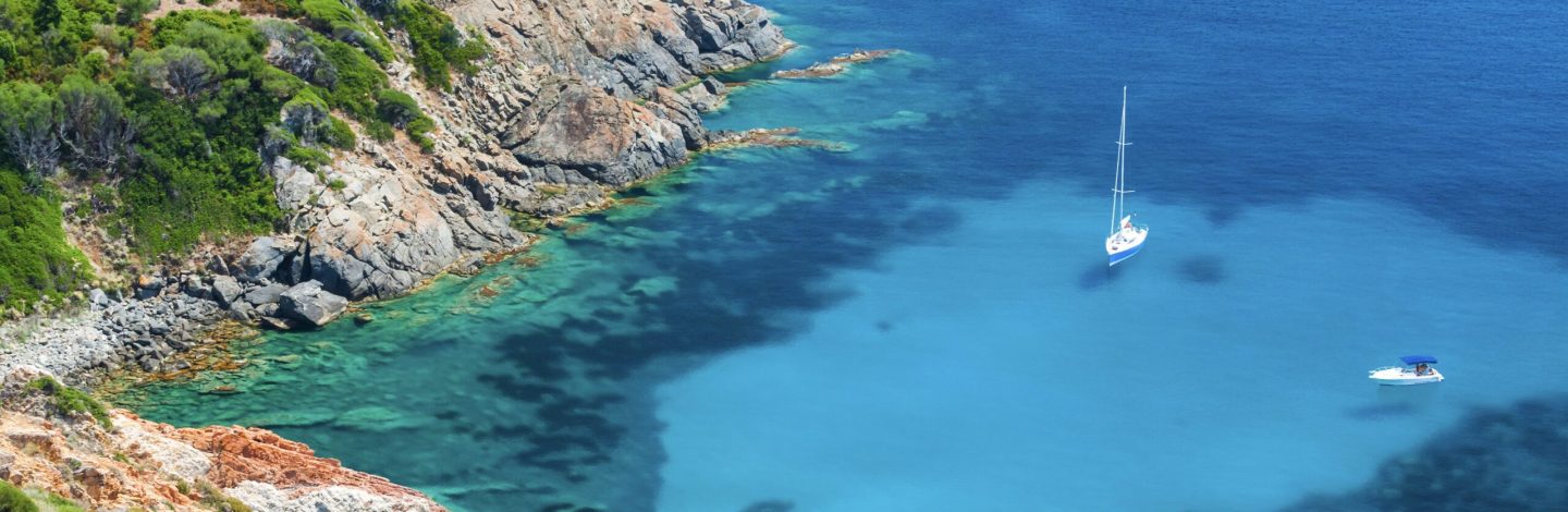 Coastal summer landscape of South Corsica, yachts moored in azure bay